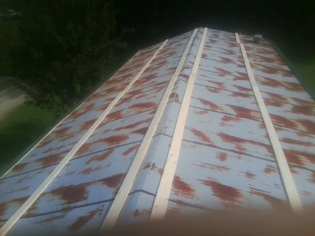 Rusted metal roof panels with new wood purlins before replacement — Storm Damage Roof Repair in Lyme by Roofing Brothers