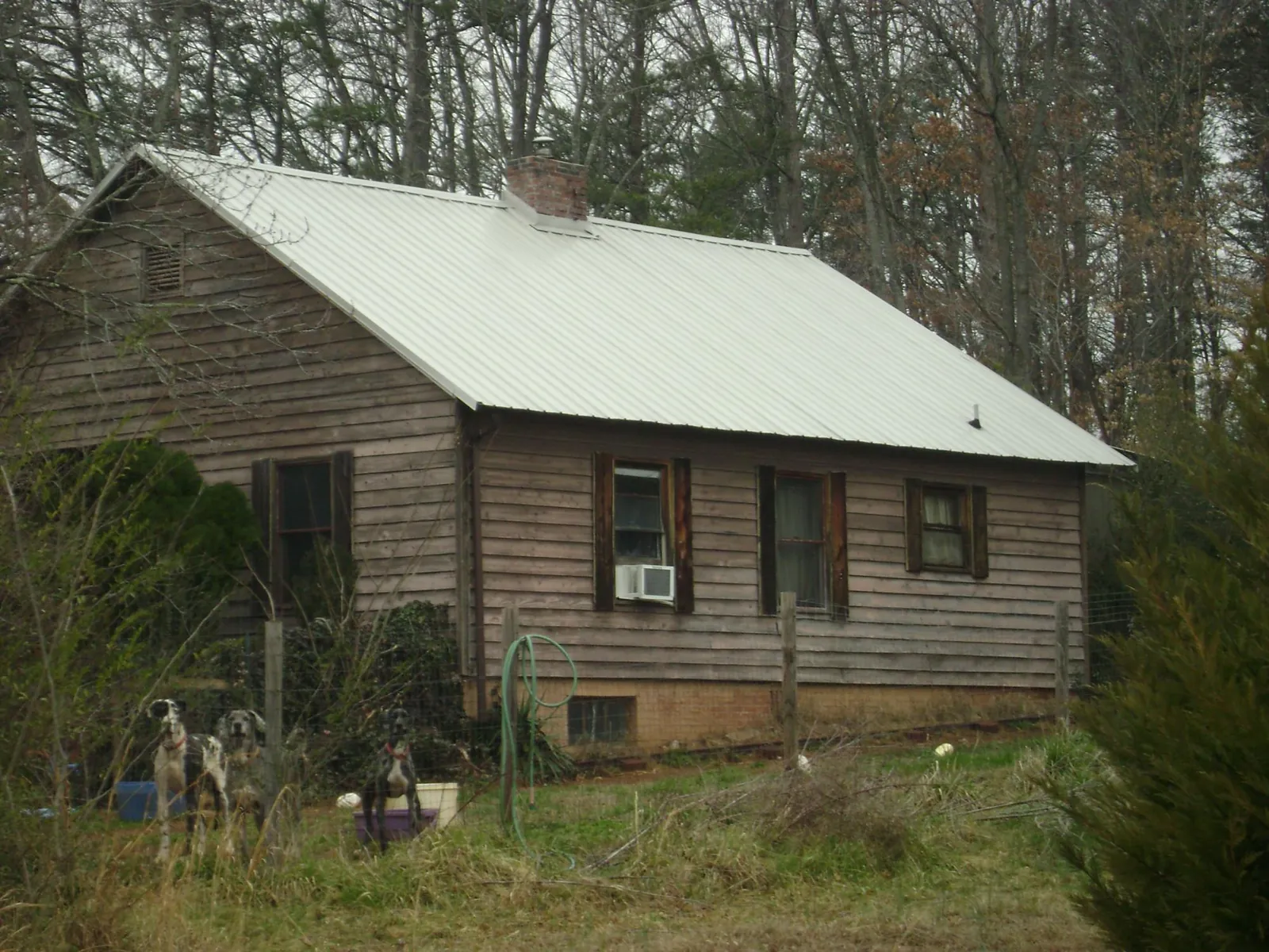 White metal roof on an old wood sided farmhouse, from a Metal Roof Installation job in Lyme